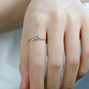Detail of S925 silver gold ring featuring oval blue topaz and yellow sapphire stones