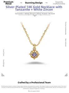 Close-up of 14K gold plated silver necklace featuring square tanzanite and white zircon