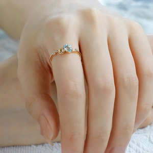 Macro detail of S925 silver 14K gold ring featuring sky blue topaz and yellow gemstones