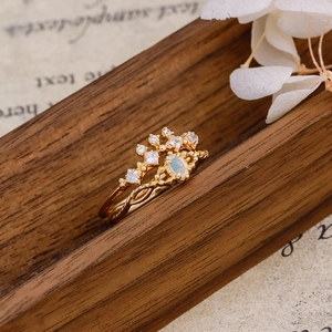 Detail view of vintage S925 silver 14K gold rings with opal and crown diamond setting