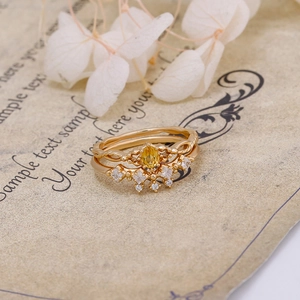 Primer plano de un conjunto de anillos de corona de plata S925 con cristal amarillo y circon