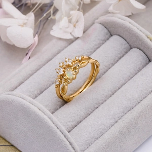Detail view of gold S925 silver opal ring with crown diamonds and vintage leaf texture