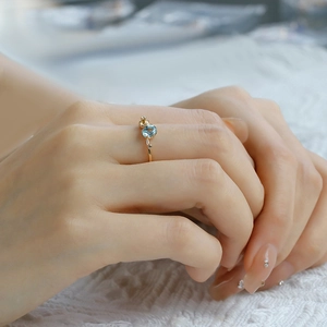 Detailed view of S925 silver 14K gold ring with oval blue topaz and yellow stone accent