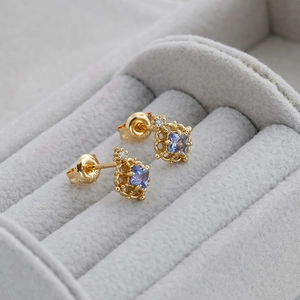 Detail of vintage gold-plated S925 earrings with square purple stone and S925 hallmark