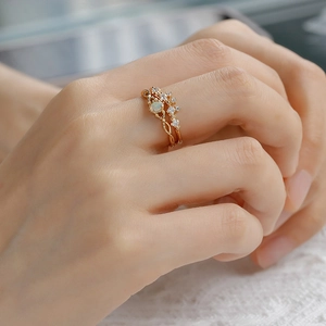 Detailed close-up of 14K gold plated opal ring with vine texture and zircons on lace