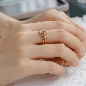 Detailed close-up of a vintage 14K gold S925 silver opal ring set on a lace background