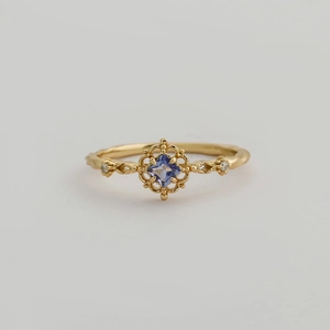 Macro shot of gold S925 silver ring with hollow design and square purple tanzanite