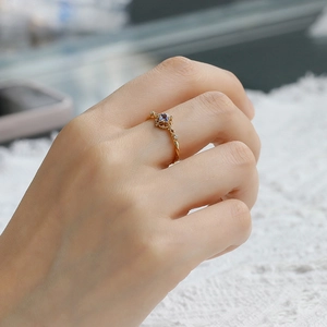 Detailed view of an S925 silver ring with tanzanite gemstone worn on a finger