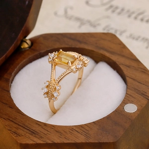 Detail of a vintage 14k gold plated ring with amber stone in a luxury wooden box