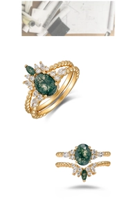 Macro detail of retro moss agate ring set with twisted gold band and white side stones