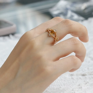 Detailed view of an S925 silver 14k gold geometric ring with citrine and small side diamonds