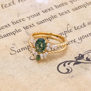 Detail of vintage gold ring set featuring oval green moss agate and twisted rope band