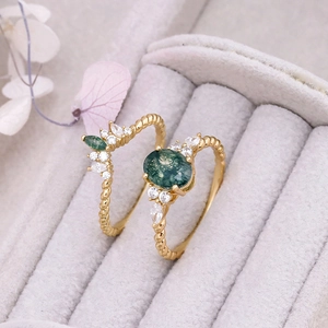 Macro detail of moss agate ring set in 14K gold with twisted band and zircon accents