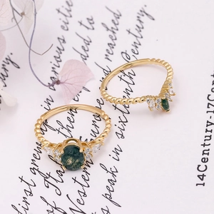 Detailed macro view of S925 silver 14K gold plated rings with green moss agate stones