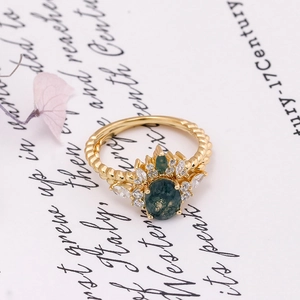 Close-up of vintage S925 silver 14K gold ring with green moss agate and white zircons