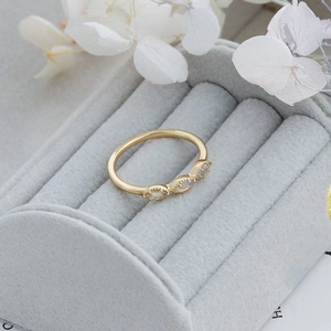 Detail of vintage sterling silver gold-plated ring with three oval opal stones
