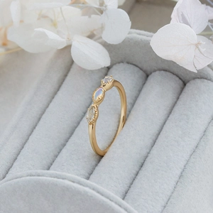 Close-up of a gold-plated sterling silver ring with opal and stones in a velvet box