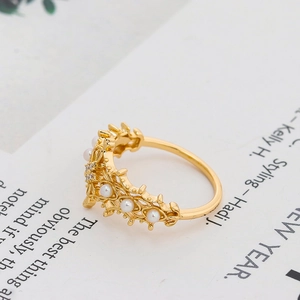Detail eines kronenförmigen Goldrings mit Süßwasserperlen und Diamanten auf Magazin