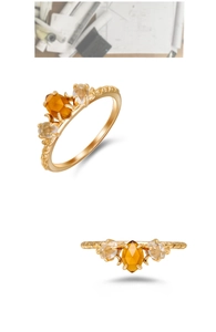 Macro de un anillo de plata 925 bañada en oro con granate naranja y cristales blancos