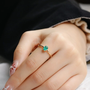 Close-up of an oval green chalcedony stone set in a minimalist gold silver ring for women