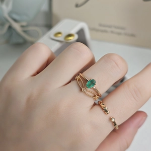 Detailed view of 18k gold plated ring set with oval green chalcedony and vintage texture