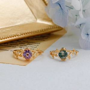 Detailed view of sterling silver leaf vine rings with amethyst and moss agate gemstones