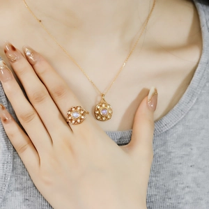 Close-up of 14k gold plated S925 silver necklace and ring set with blue moonstone