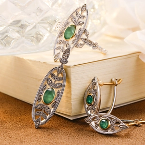 Detailed view of vintage S925 silver ring and earrings with green chalcedony stones