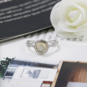 Macro detail of octagonal labradorite ring with gold trim and hollow carved patterns