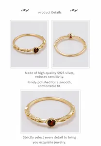 Detail view of gold-plated S925 silver ring featuring red garnet and vintage floral textures