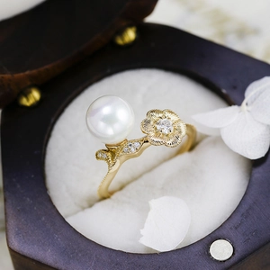 Macro detail of luxury lotus shell pearl ring with moissanite in wood jewelry box
