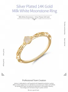 Macro shot of 14K gold plated silver ring featuring a milky white moonstone and woven texture