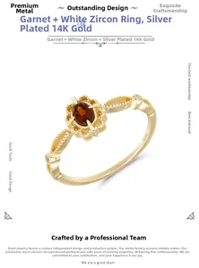 Detailed macro view of S925 engraved gold-plated silver ring with garnet and white zircon