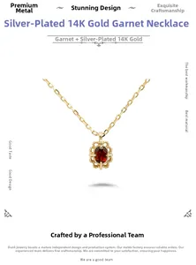 Macro view of garnet pendant necklace in 14K gold plated silver with vintage filigree