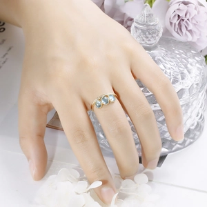 Close-up of three oval blue stones set on a thin gold-plated S925 silver ring band