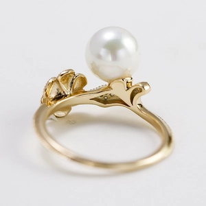 Luxurious lotus pearl ring with moissanite accents and intricate hollow gold petals