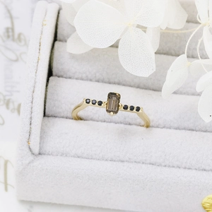 Macro detail of octagonal smoky quartz ring set in S925 silver with black side diamonds