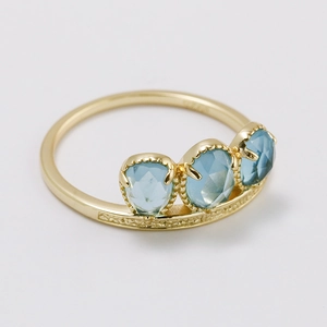 Vintage style S925 silver gold-plated ring featuring three light blue pear-cut gemstones