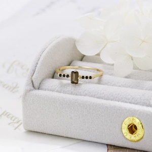 Macro detail of S925 silver gold ring with octagonal smoky quartz and black zircon stones
