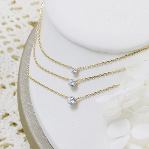 Detailed comparison of three pendant sizes on gold chain necklace with cubic zirconia