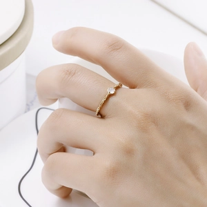 Detailed close-up of S925 silver gold-plated ribbon ring with natural garnet stone