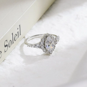 Detailed macro shot of a marquise cut silver ring with a sparkling halo and diamond accents