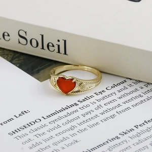 Detail view of heart-shaped red agate stone and S925 engraving on gold-plated ring