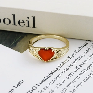 Macro view of S925 sterling silver heart ring with red agate and vintage relief patterns