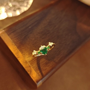 Detalle del anillo de esmeralda vintage en forma de corazón con diamantes luz