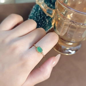 Macro shot of gold-plated silver ring featuring oval green chalcedony and side diamonds