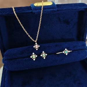 Close-up of elegant S925 silver opal snowflake jewelry set in a blue velvet box