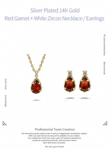 Macro shot of garnet jewelry set featuring drop-cut red gemstones in 14K gold plating