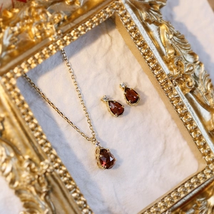 Garnet jewelry set with pear-shaped red stone necklace and earrings in gold-tone silver