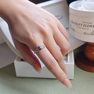 Close-up of London blue topaz ring in gold-plated silver worn on female hand